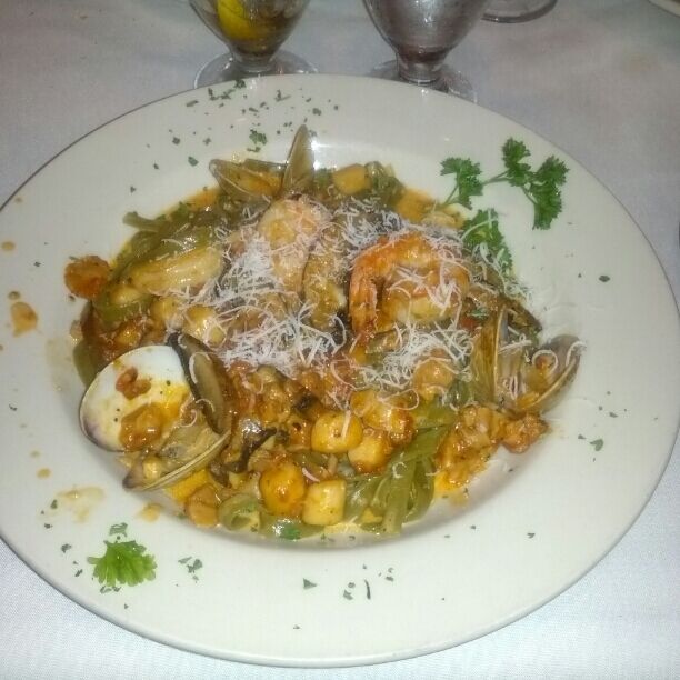 Spinach fettuccine with shrimp, scallops, clams, mussels and portobello mushrooms. 