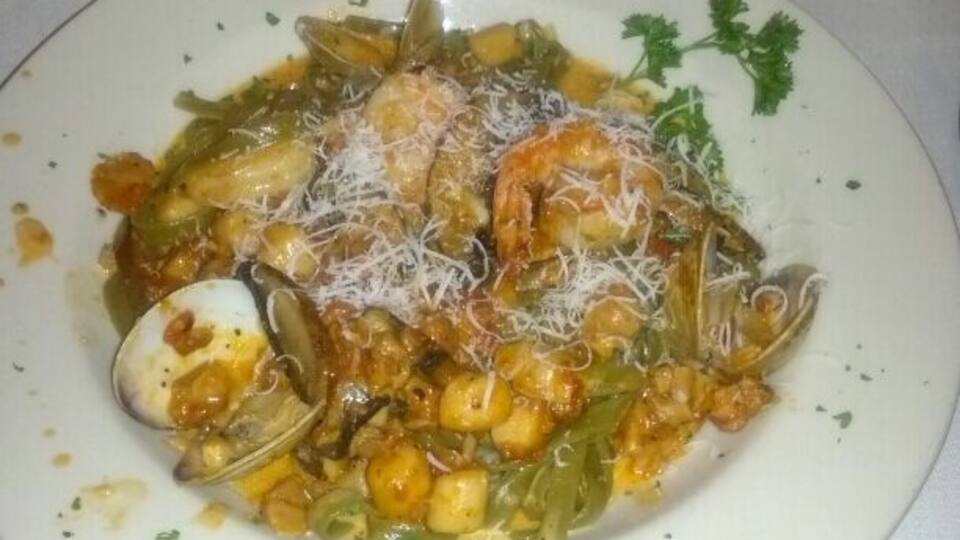 Spinach fettuccine with shrimp, scallops, clams, mussels and portobello mushrooms.