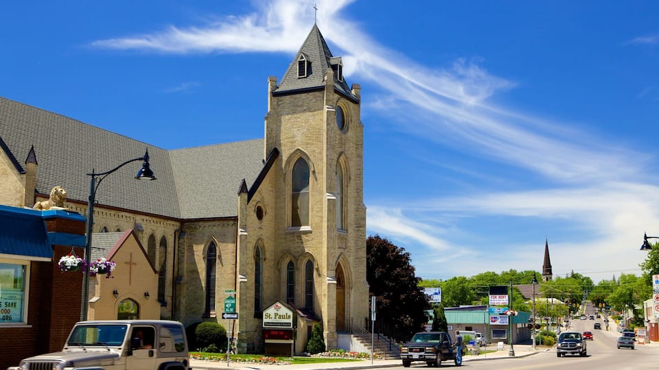 A church with a tall steeple and a lion statue on the roof.