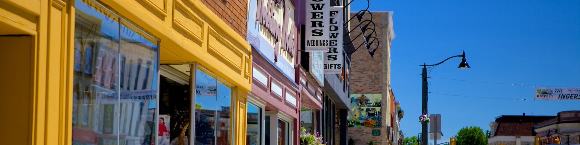 A street with flower shops and a sign for a wedding florist.