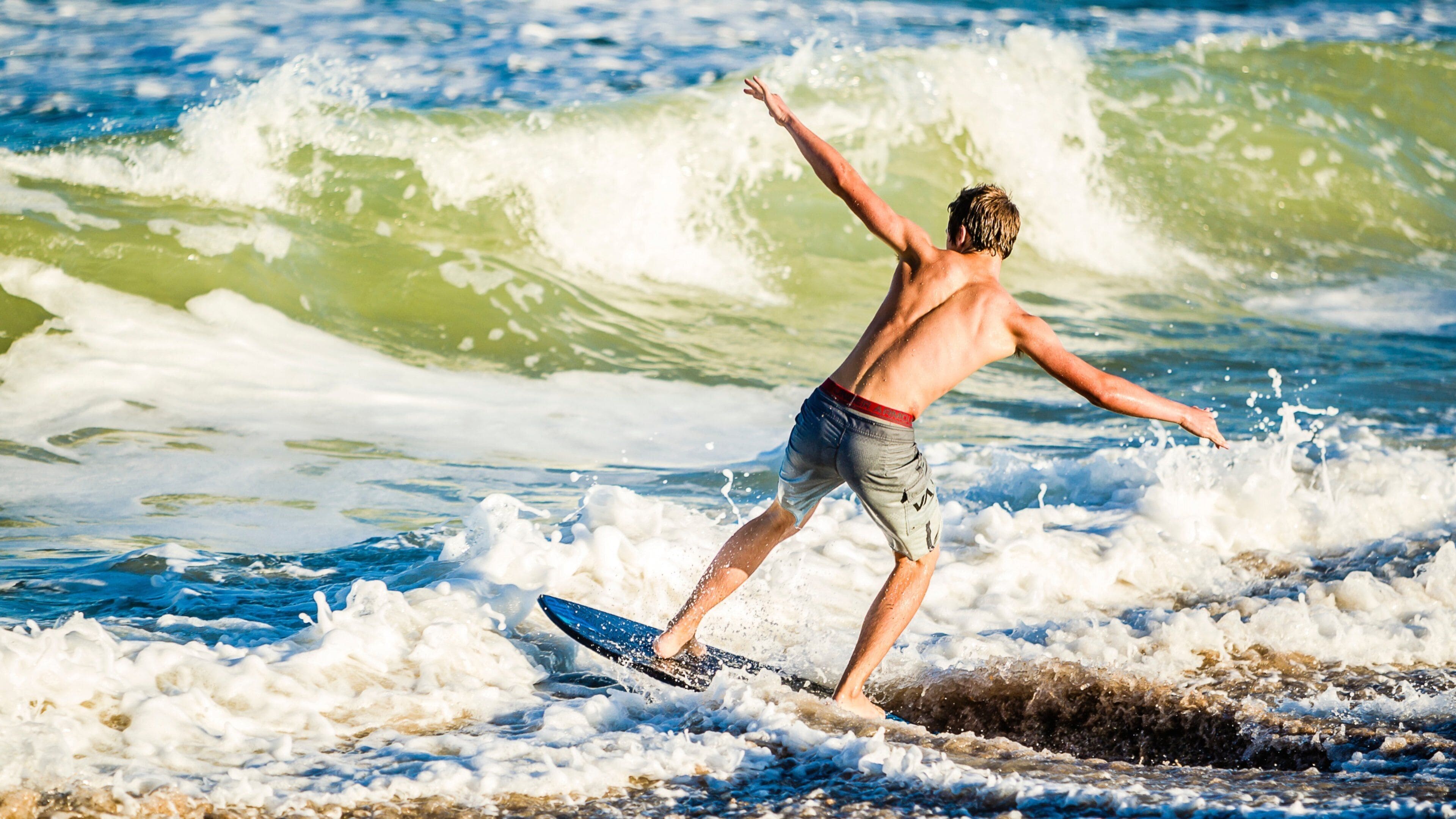A surfer riding a wave in the ocean.
