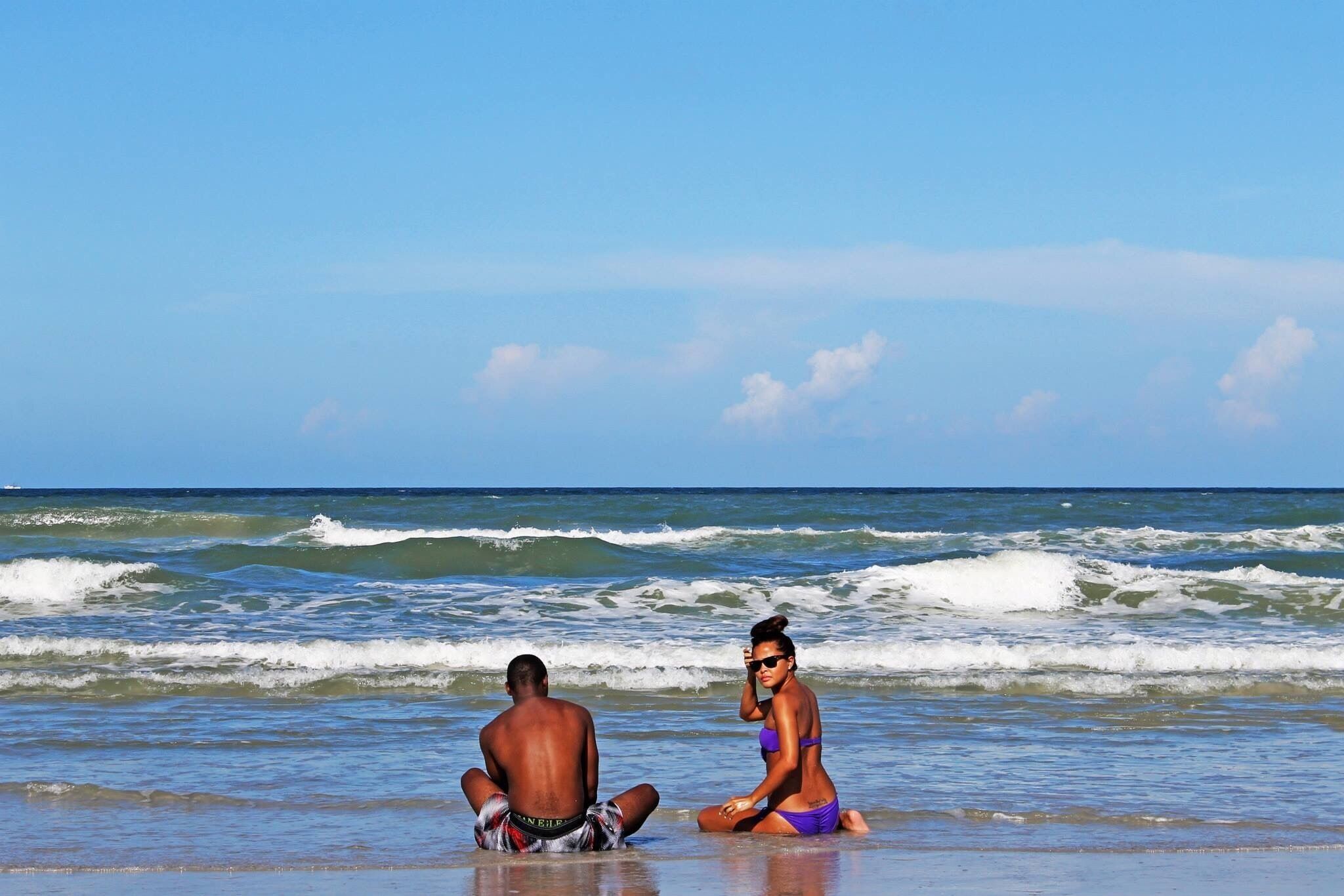 My cousins soaking in the sand on a humid July day in Jacksonville