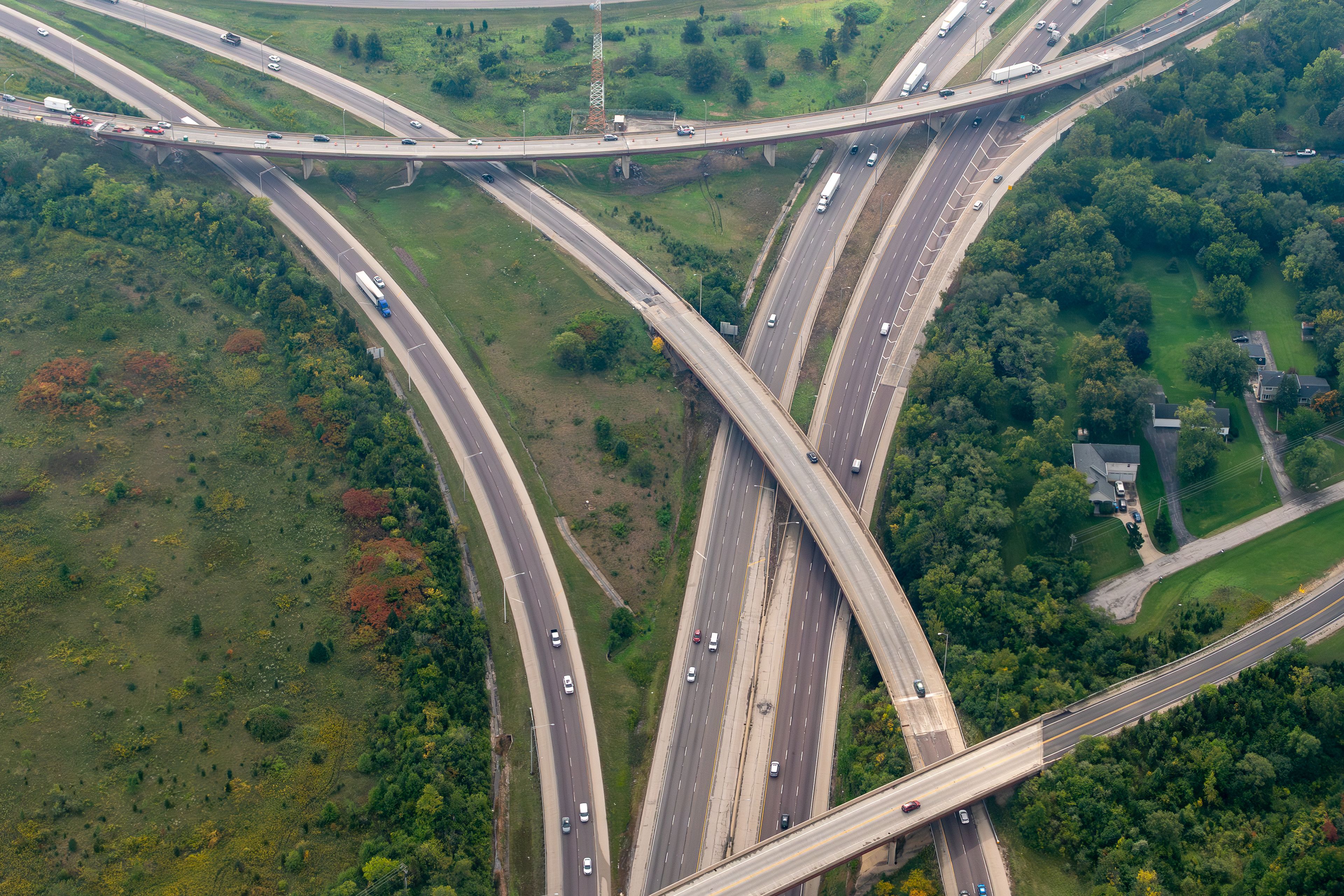 Itasca, Illinois, USA - Aerial view of the interchange of I-290 the Eisenhower Freeway and I-355 Veterans Memorial Tollway  in the Chicago Suburbs featuring overpass, homes, and trucks