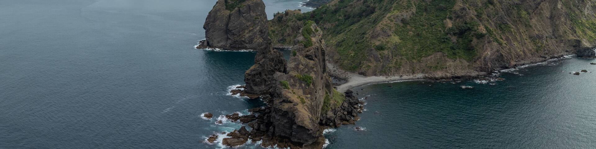 Rocky healand of Fletcher bay in the far north of Coromandel, Coromandel Peninsula, New Zealand.