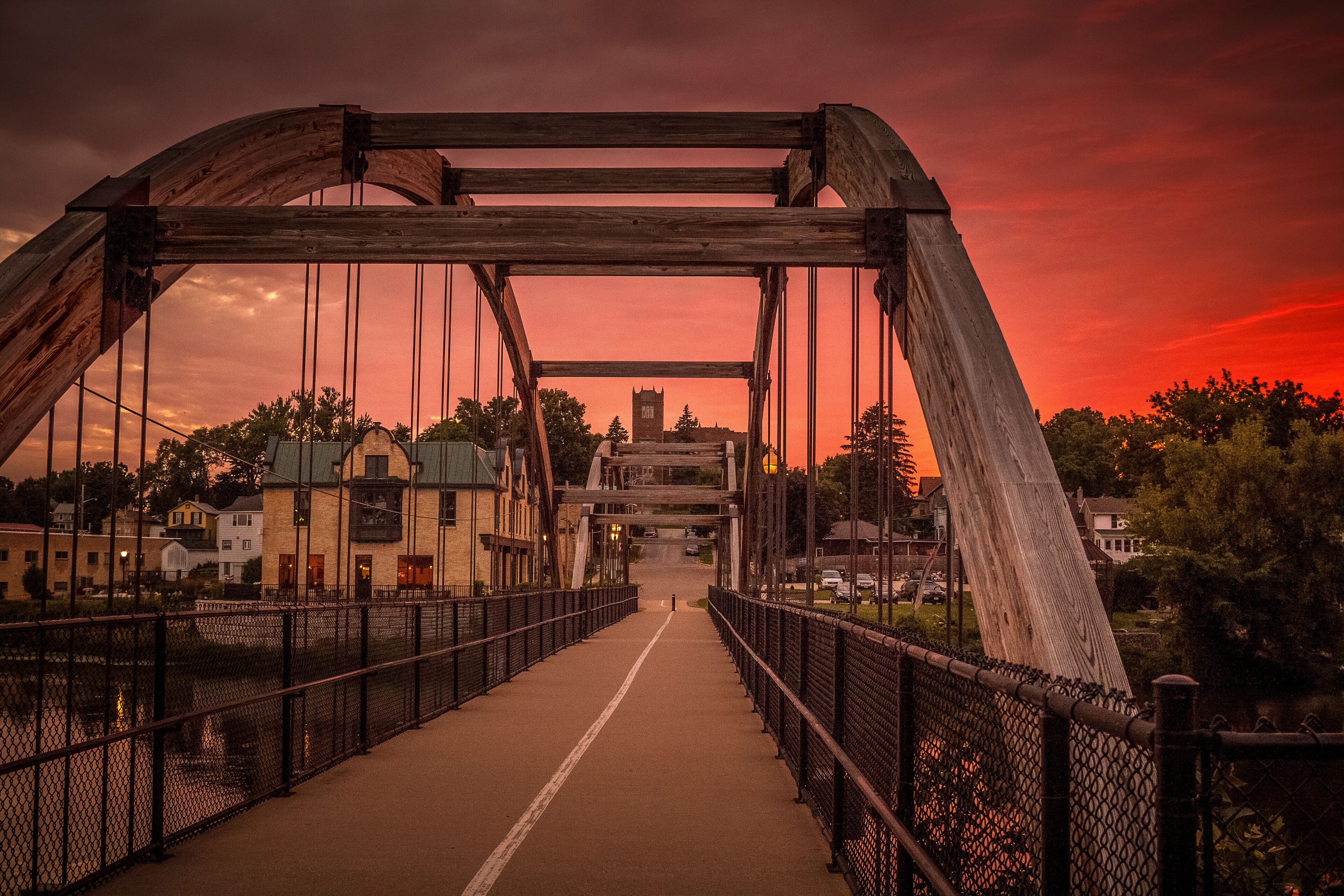 The arched walk bridge in Jefferson, Wisconsin and a red sunset