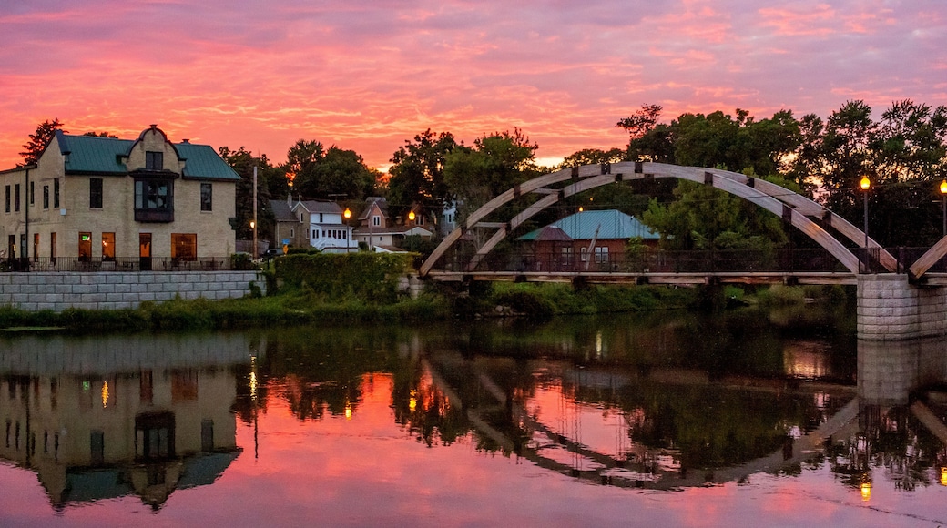 A very colorful sunset over Jefferson, Wisconsin reflected in the Rock River with the arched walk bridge.