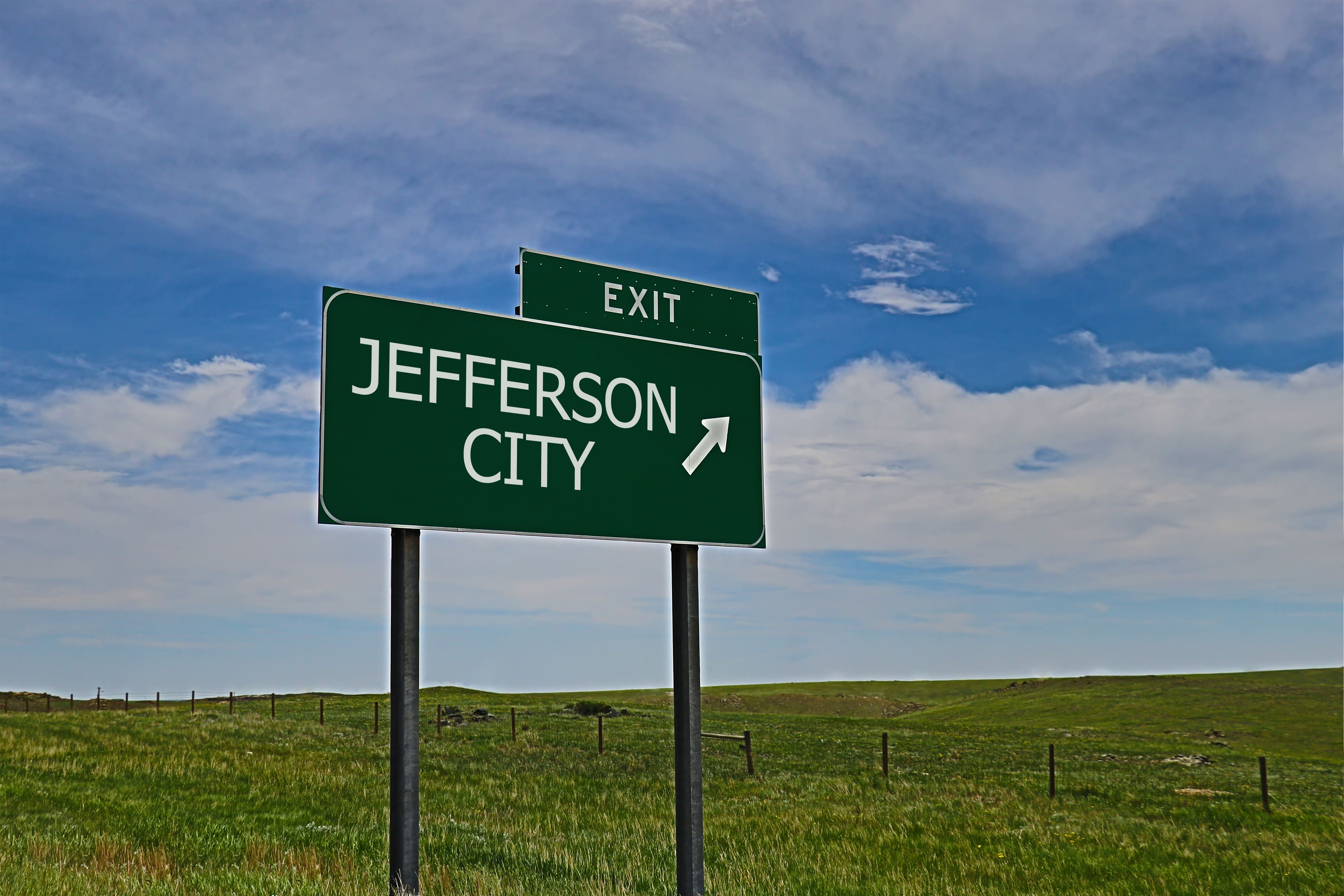 A green highway exit sign for Jefferson City with an arrow pointing right.