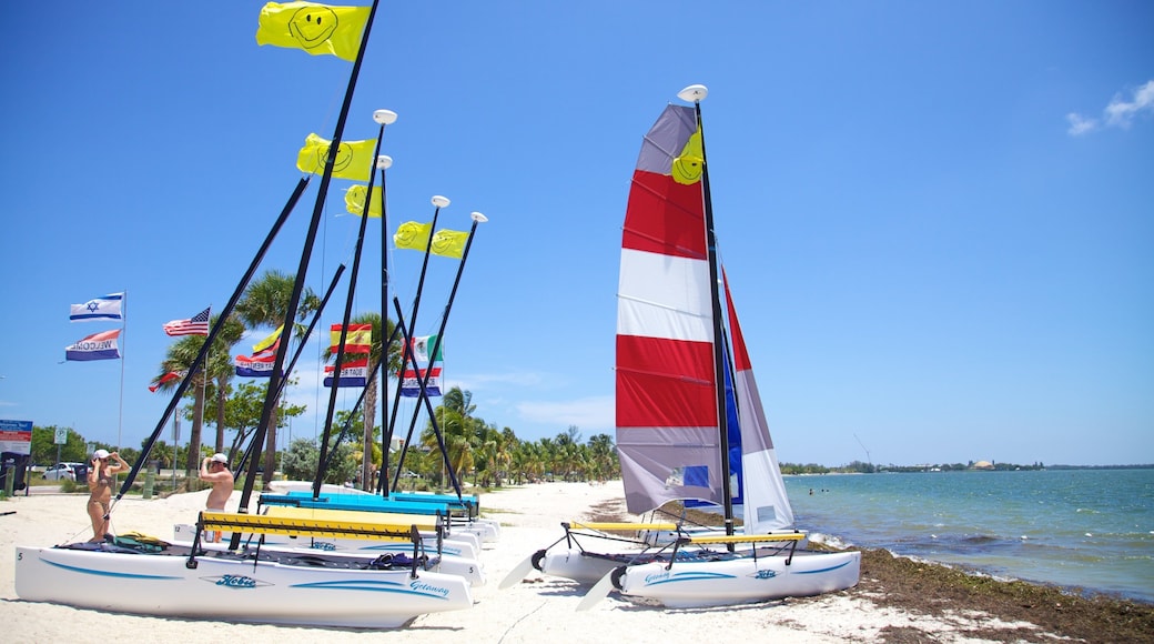 Sunlit Key Biscayne beach with colorful sailboats and vibrant flags on a clear day in Florida