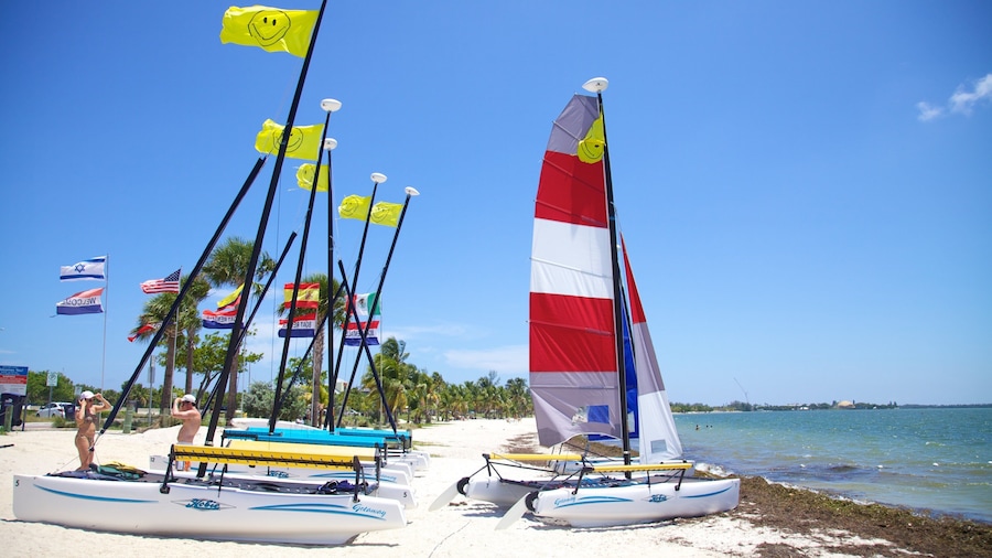 Sunlit Key Biscayne beach with colorful sailboats and vibrant flags on a clear day in Florida