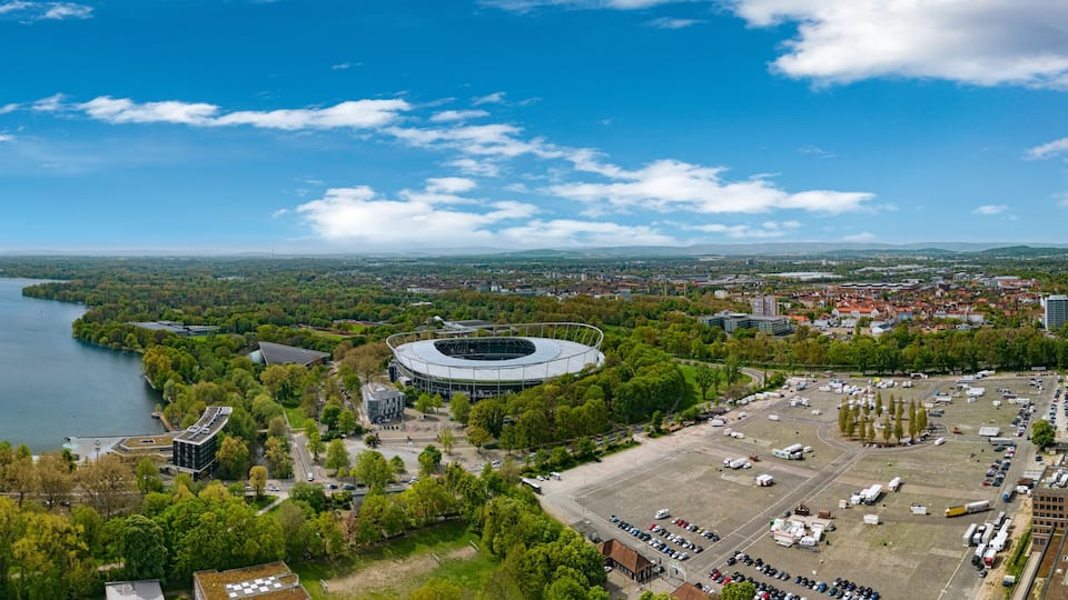 A river, a stadium, and a cityscape with buildings and greenery.