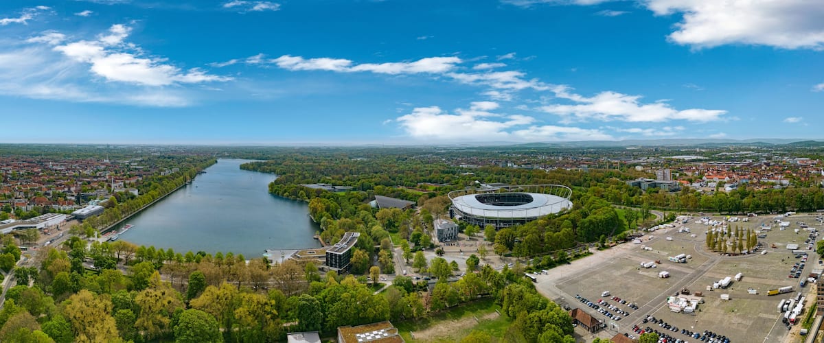 A river, a stadium, and a cityscape with buildings and greenery.