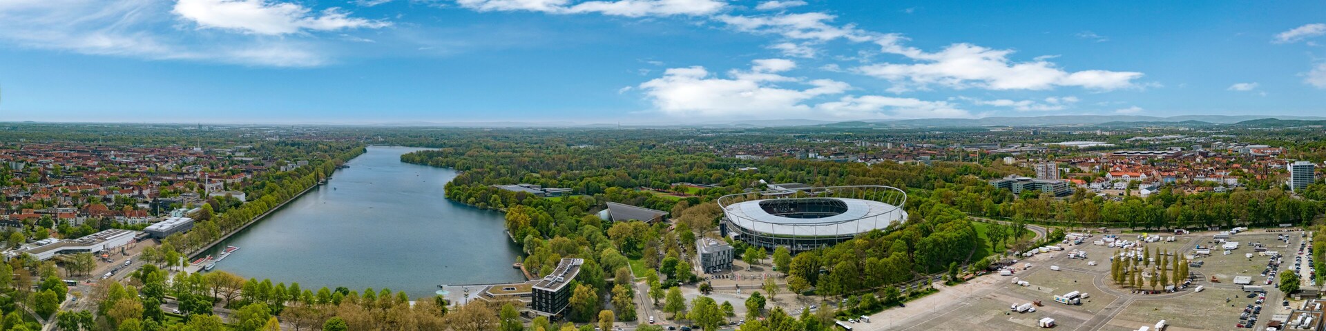 A river, a stadium, and a cityscape with buildings and greenery.