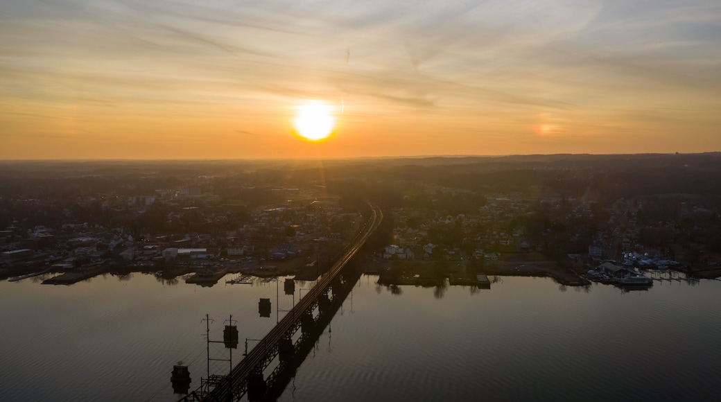Aerial view of the bridge over the serene water reflecting the golden hues of the setting sun, Perryville, Maryland, United States of America.