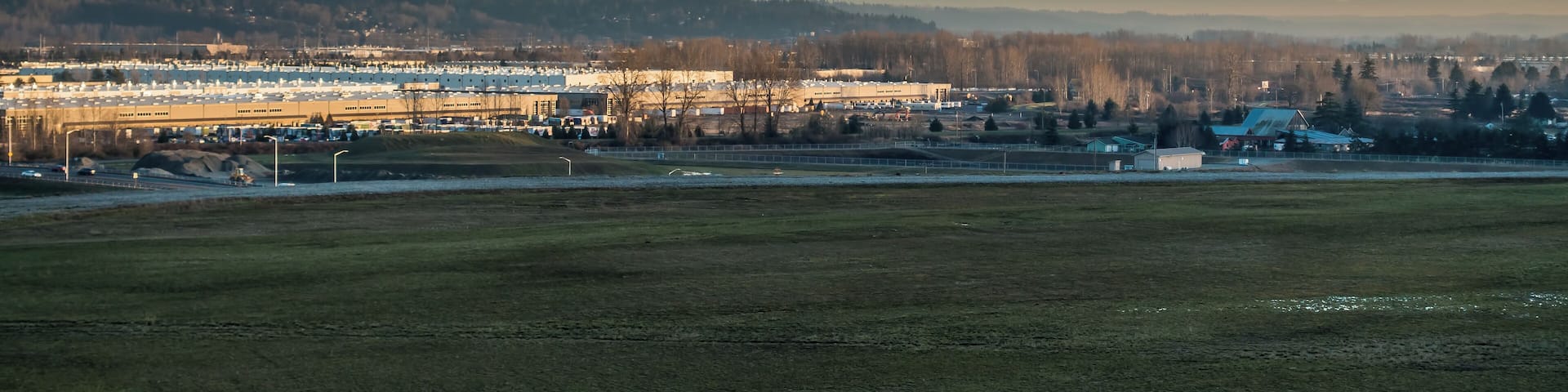 Mount Rainier rises above warehouses in Kent, Washington.