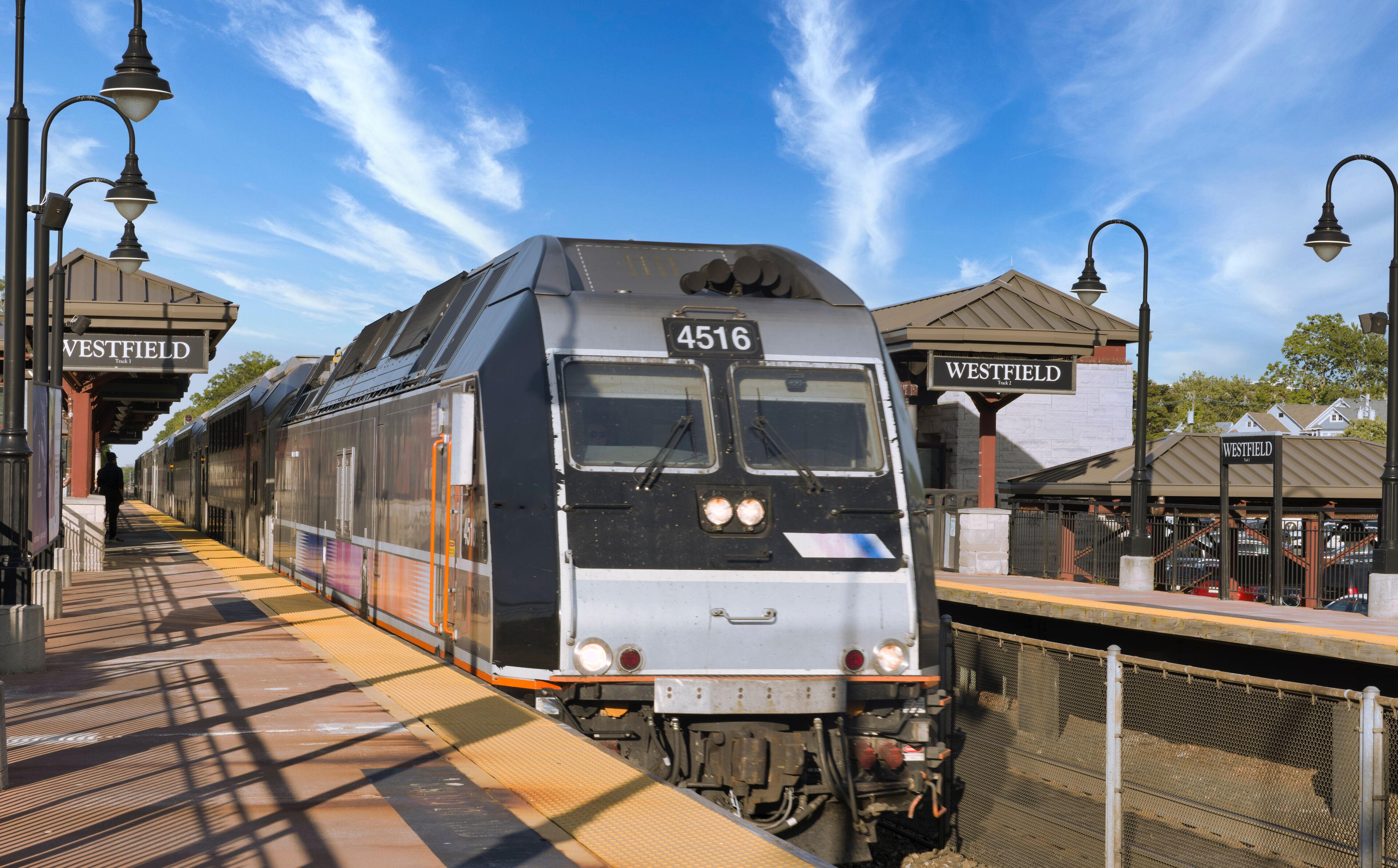 A train at a station with signs reading "WESTFIELD".