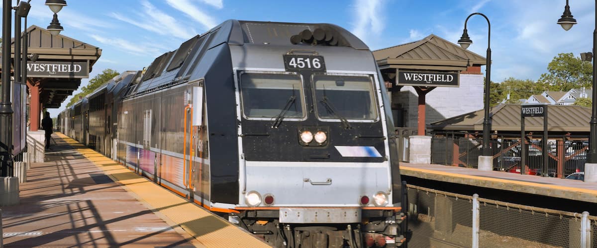 A train at a station with signs reading "WESTFIELD".