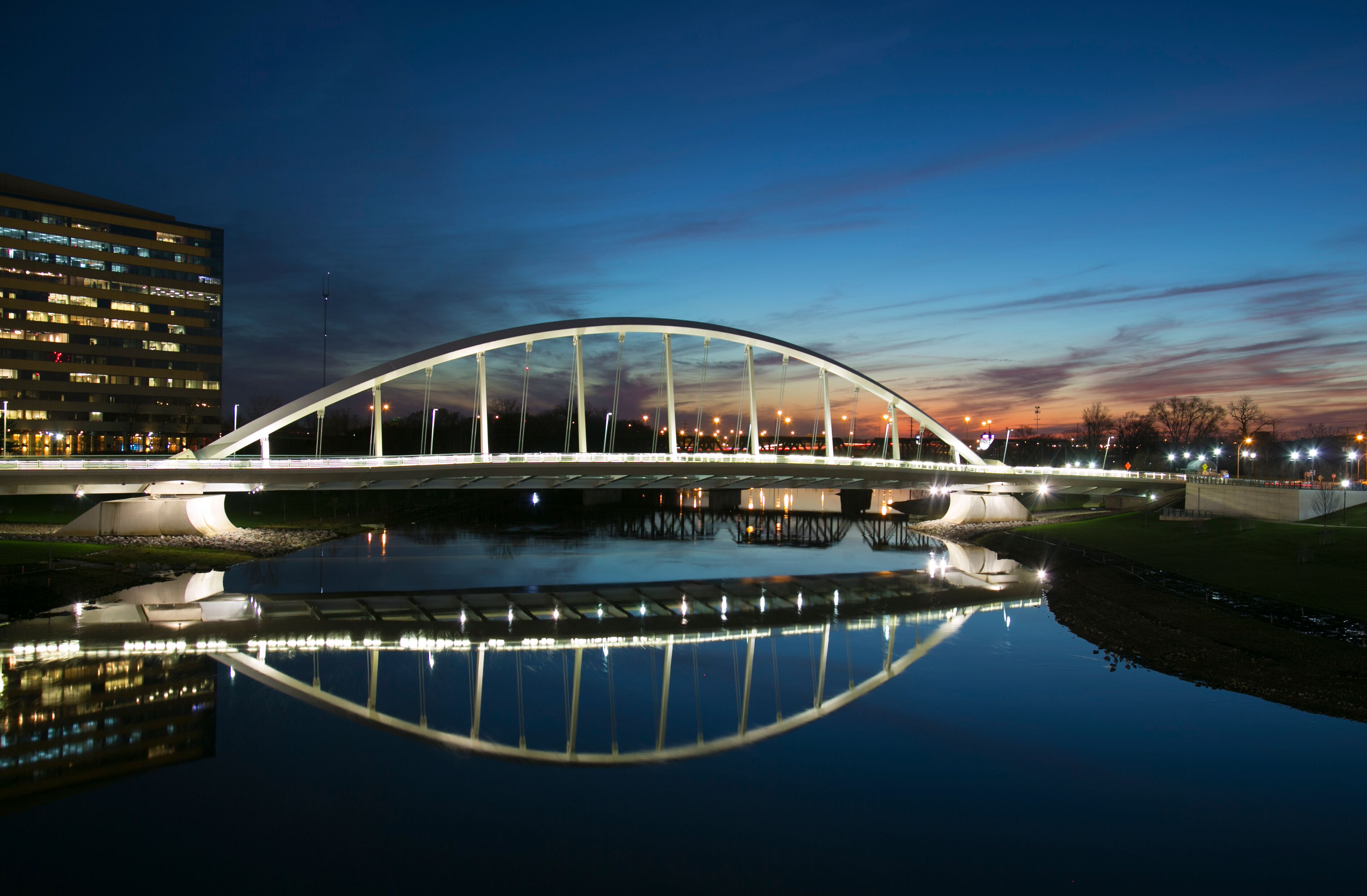 Main Street Bridge downtown Columbus, Ohio at dusk with deep blue sky and reflection in river