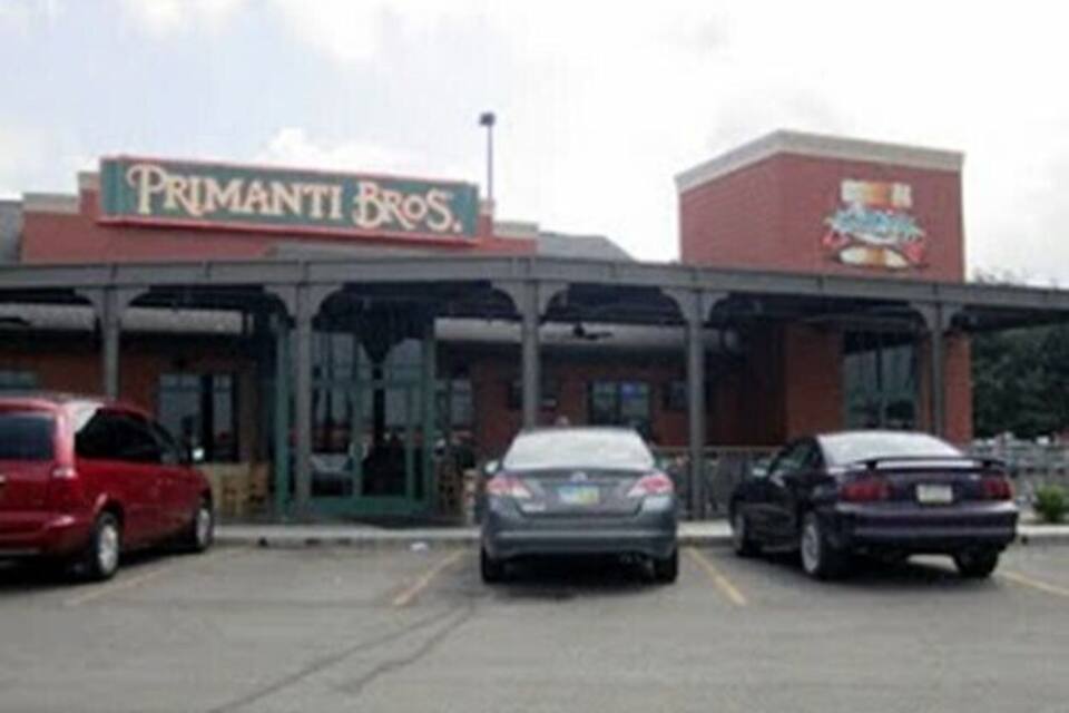 A parking lot with a building labeled "Primanti Bros."