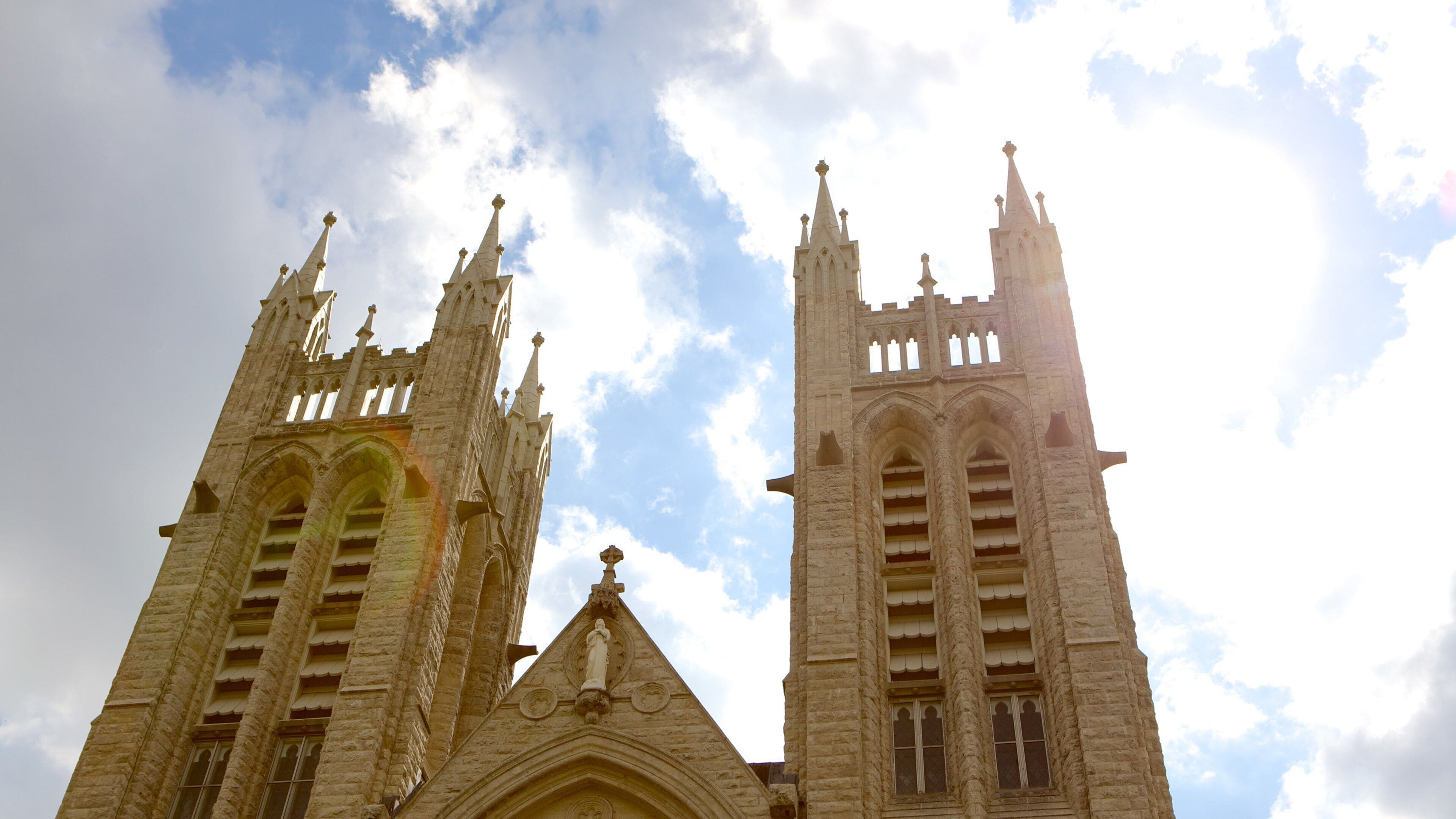 A Gothic-style church with two tall towers and a pointed roof.