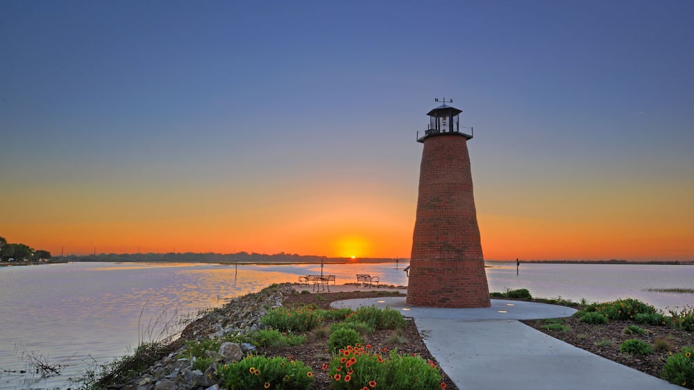 Dawn view over Lake Toho (Lake Tohopekaliga) in Kissimmee Florida including walkway and mini lighthouse.