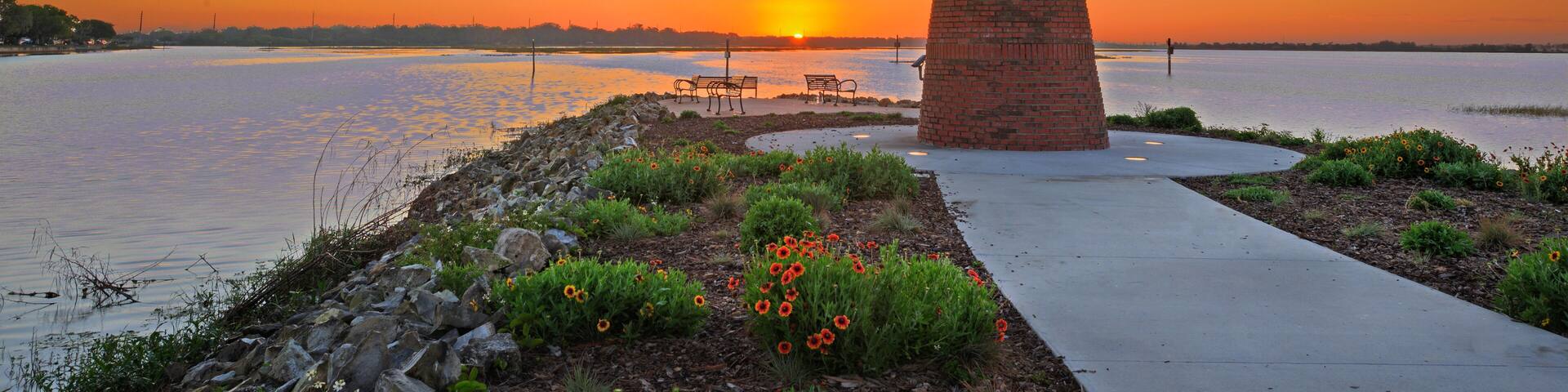 Dawn view over Lake Toho (Lake Tohopekaliga) in Kissimmee Florida including walkway and mini lighthouse.