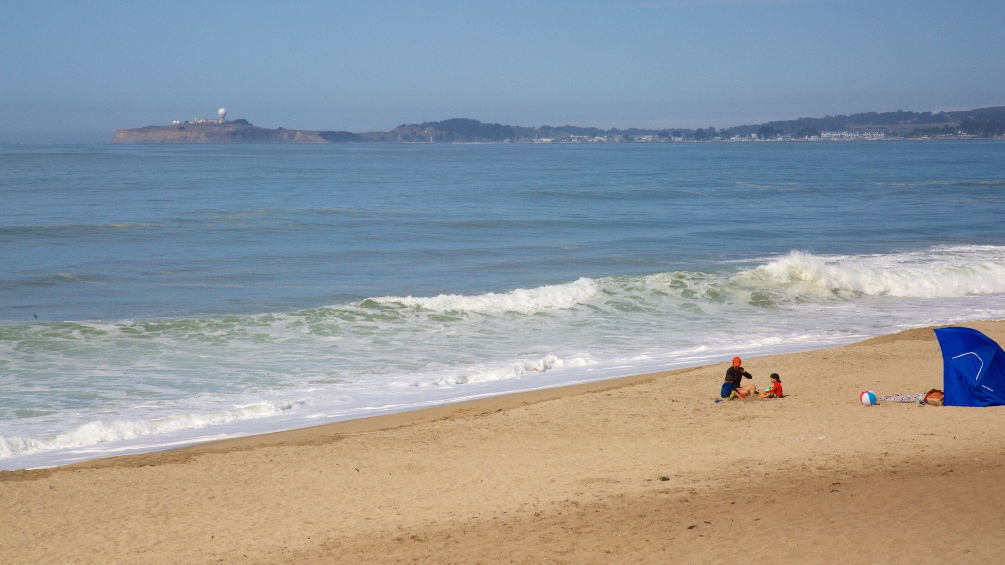 Half Moon Bay featuring general coastal views and a sandy beach as well as children