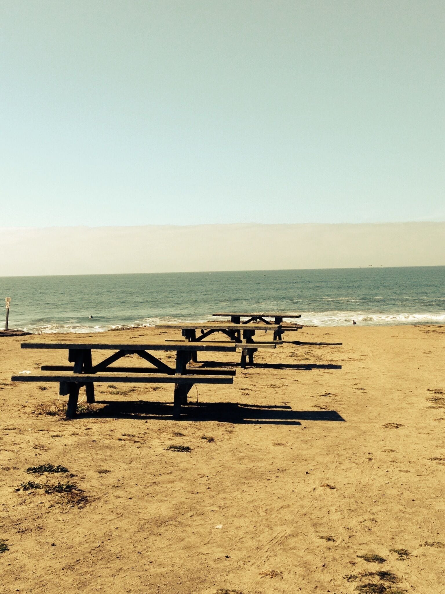 Half Moon Bay beach, California. 

A perfect setting for a romantic day out with your partner. Sea, sun, sand and these benches to enjoy the bar-be-cue with beer. 