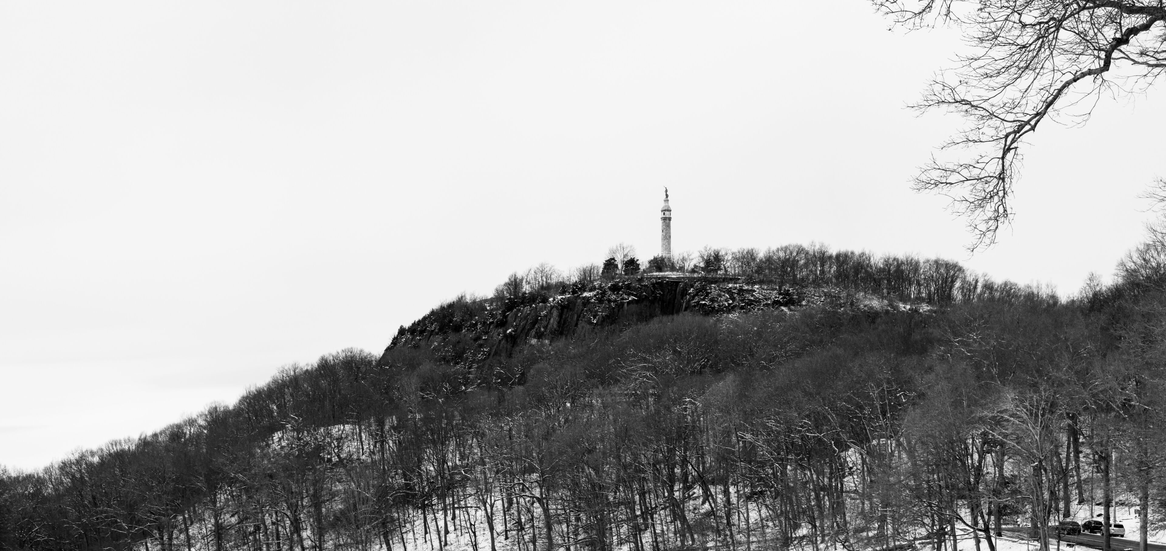 East Rock Park Hill covered with snow in Hamden, New Haven County, Connecticut, United States. A tranquil winter landscape of New England. Black and white photo.
