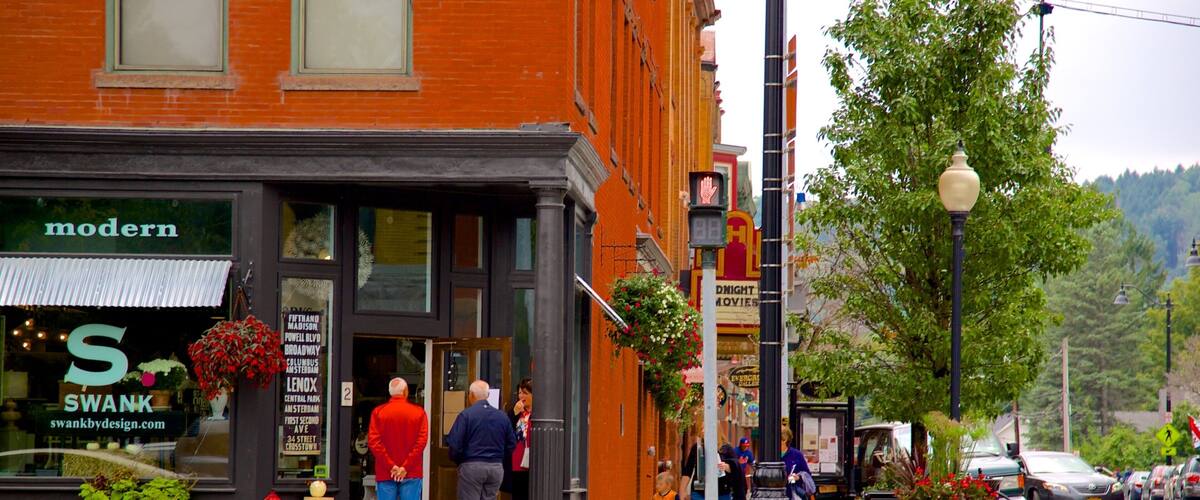 A street with a red brick building, a fire hydrant, and a pedestrian crossing.