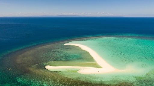 White sandy island with coral reefs.White sandbar.Atoll near the island of Camiguin, Philippines, aerial view.Seascape, white sand island