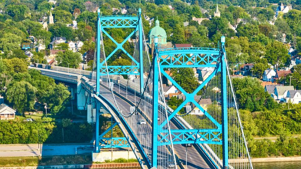 Aerial Zoom of Blue Suspension Bridge Over Maumee River Toledo