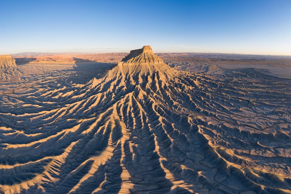 A vast desert landscape with prominent ridges and valleys.