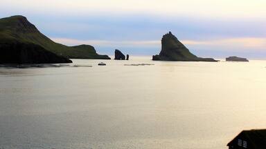 A distant view of Drangarnir, one of the most interesting natural landmarks in the Faroe Islands! Drangarnir is the sea stacks in the middle. I took this photo in/near the village of Bøur. Shortly after I visited another iconic landmark: Múlafossur Waterfall! I wish I had time to get a close-up view of Drangarnir, though. It is truly otherworldly!
I took this photo on August 29th.