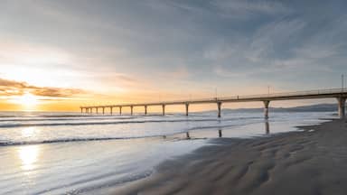 Beautiful sunrise at New Brighton Pier, Christchurch, New Zealand. It is one of eastern country's main entertainment and tourist centers, with its architecturally unique pier and scenic coastline.