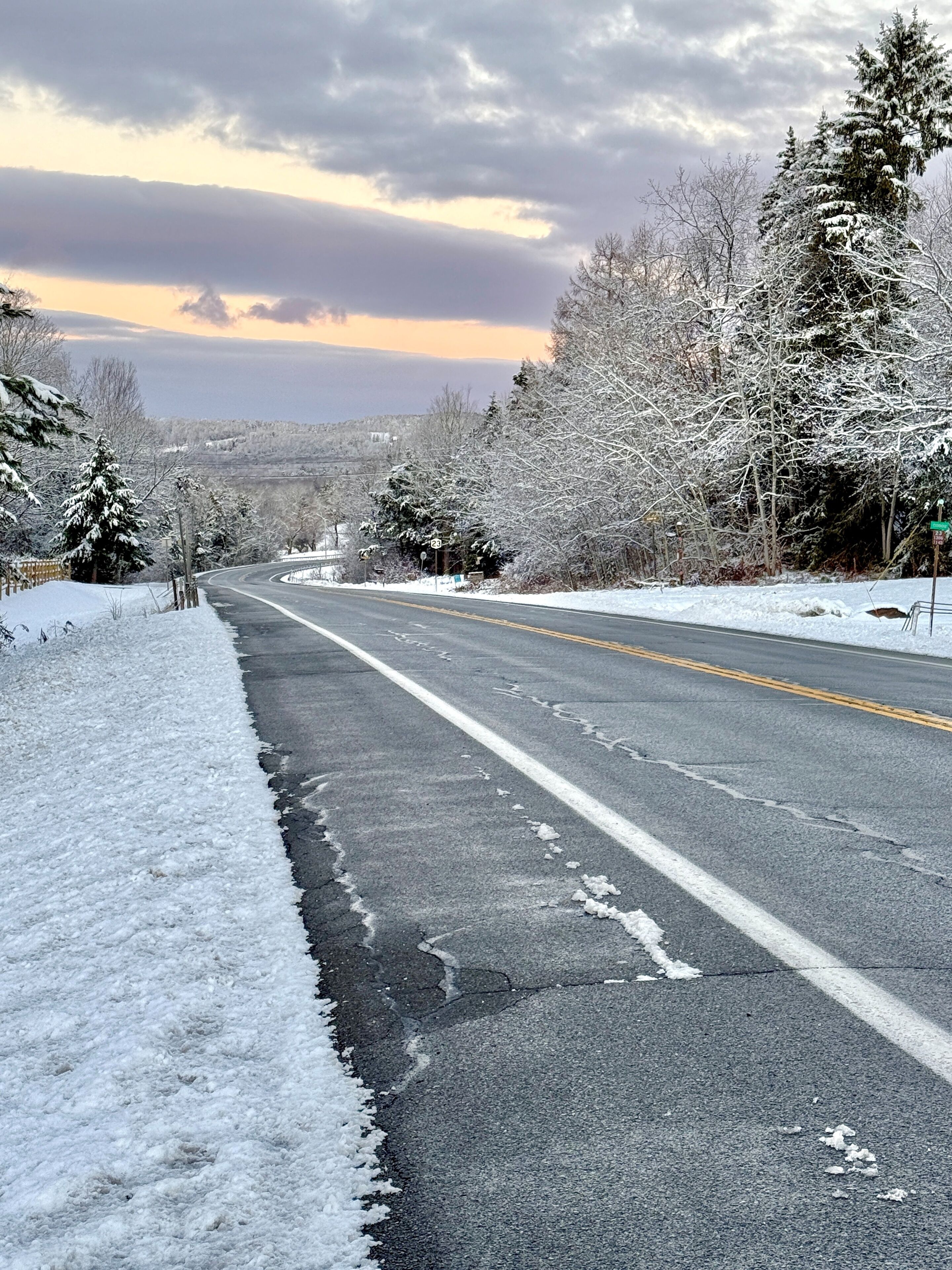 Route 23 leading to Windham Mountain in the distance.  Scenic highway with gorgeous views of snowcapped mountain in the distance at sunrise in the early morning.  