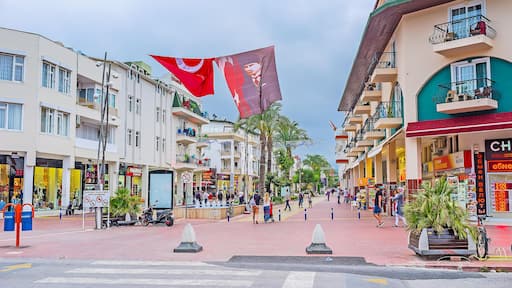 KEMER, TURKEY - MAY 5, 2017: The Munir Ozkul Liman shopping street decorated with Turkish flags and portraits of Ataturk, on May 5 in Kemer.