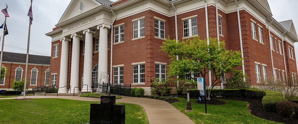 A brick courthouse with columns and a dome.