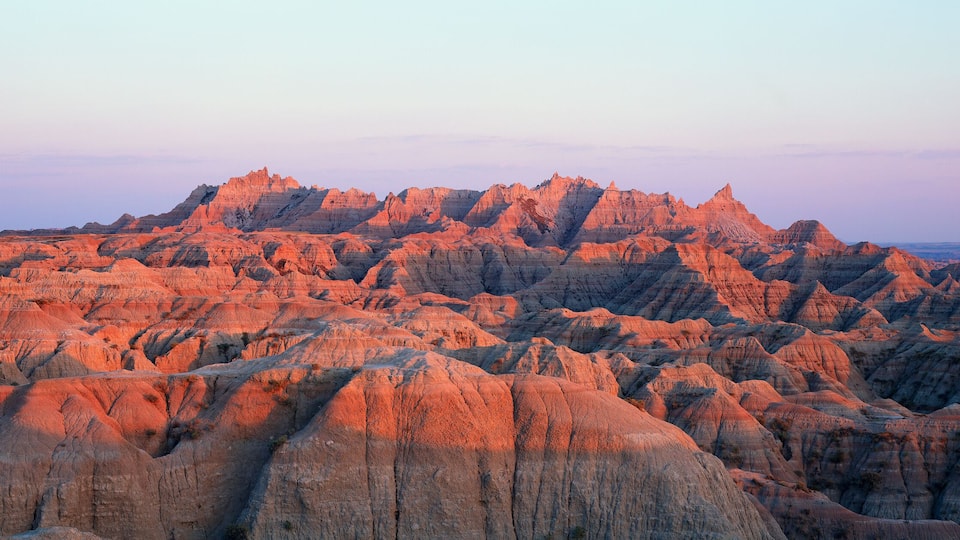 A rugged, eroded landscape with prominent ridges and valleys, likely a badlands region.
