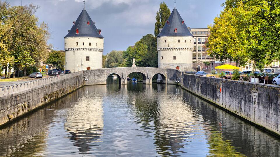 A canal with two towers and a bridge.