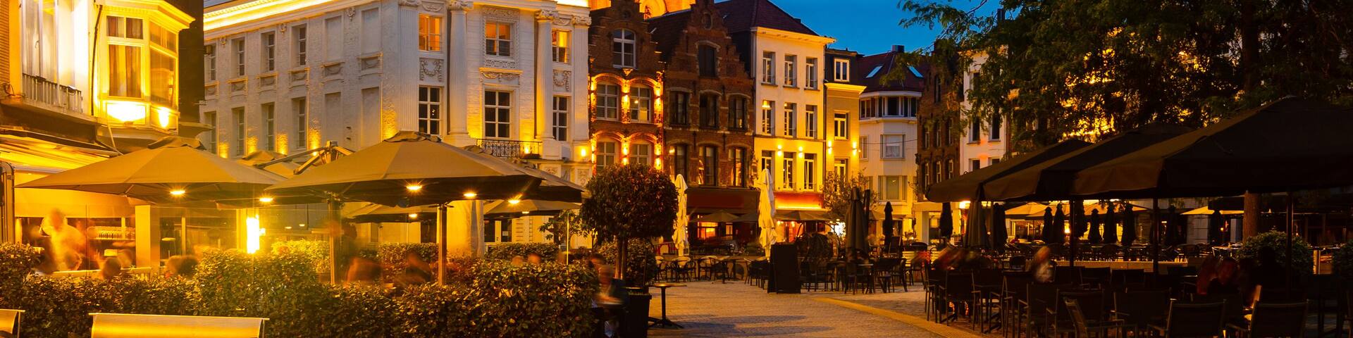 Evening central Grote Markt square with a view of the bell tower of St. Martin Church in Kortrijk, Belgium