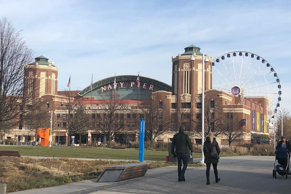 A large building with a sign reading "NAVY PEAR" and a Ferris wheel in the background.