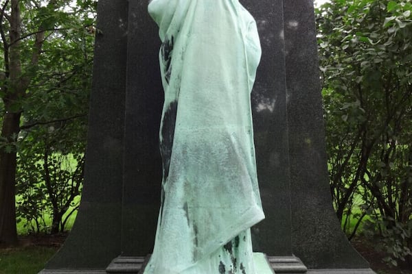 "Eternal Silence" is a monument in Chicago's Graceland Cemetery. It is a 10ft tall bronze sculpture set on and backdropped by black granite. Also referred to as the Statue of Death, it was created by American sculptor Lorado Taft in 1909. It is a monument to Dexter Graves, who brought the first colony to Chicago consisting of thirteen families who moved from Ashtabula, Ohio in 1831