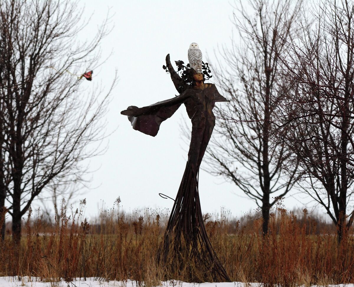 A female snowy owl perched on a statue in the park at Northerly Island. I was shocked to see this and just after I took a couple of pictures the owl flew off.