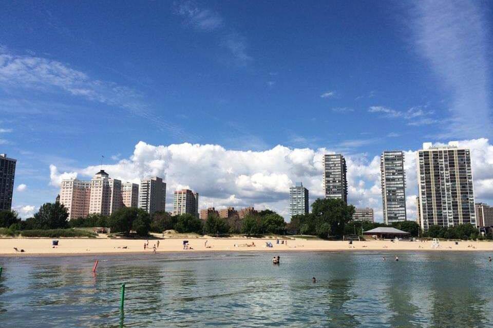 Een strand met hoge gebouwen op de achtergrond.
