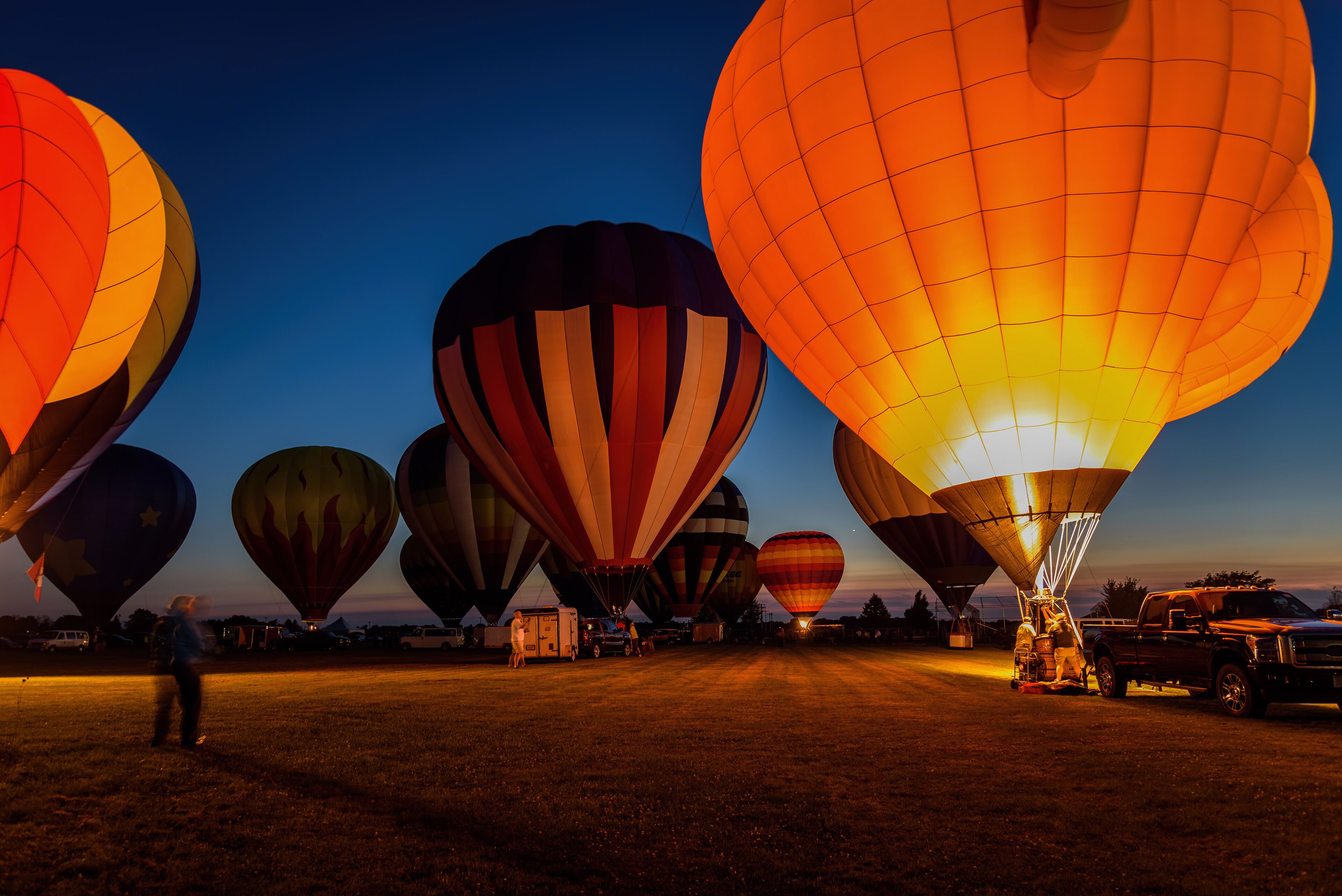 hot air balloons glowing in night sky