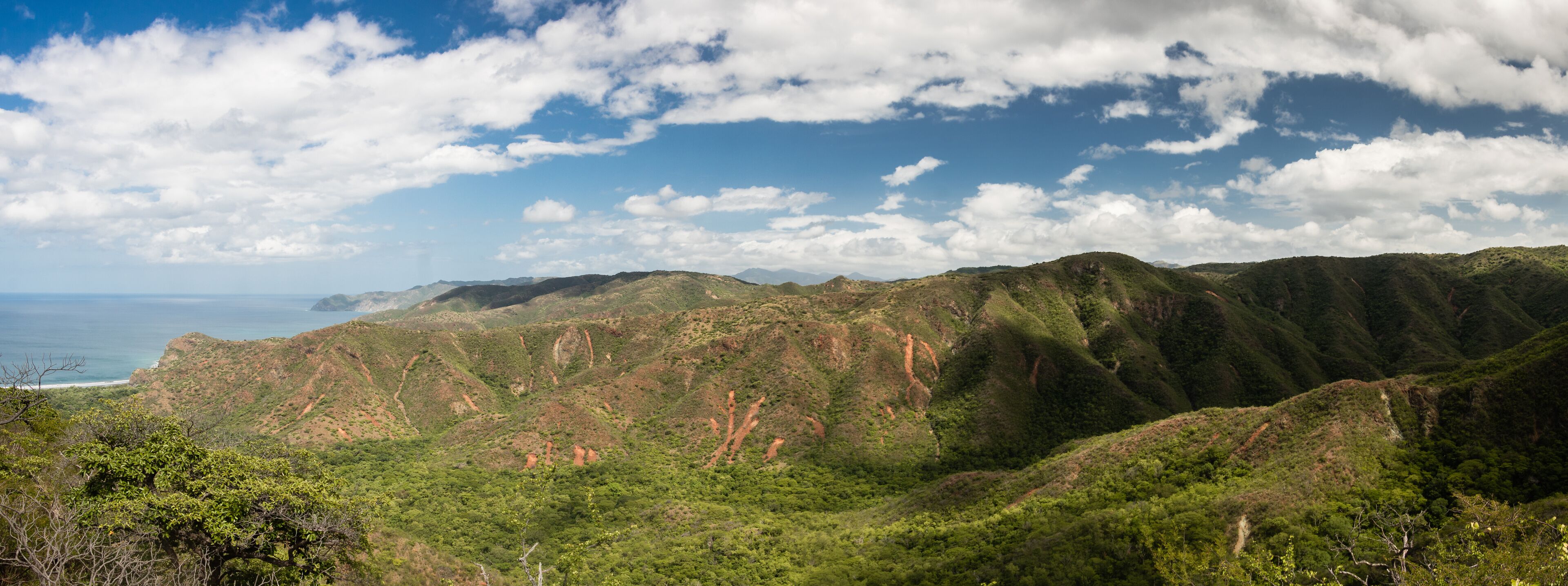 A mountainous landscape with a coastline in the distance.