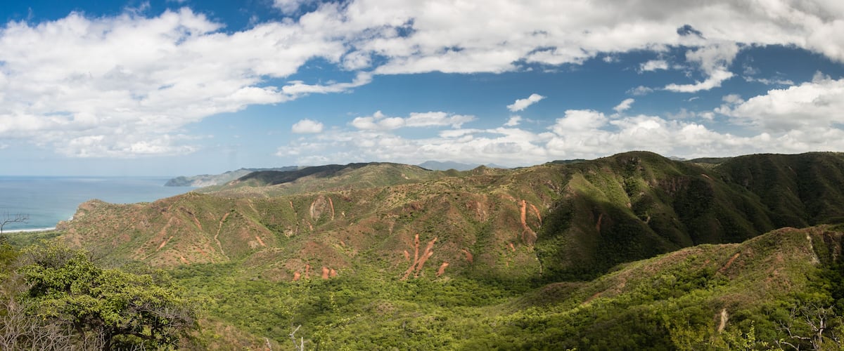 A mountainous landscape with a coastline in the distance.