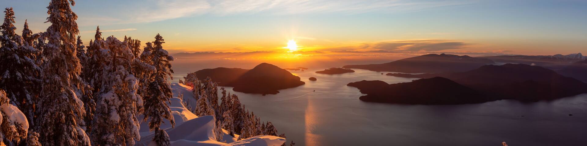 Beautiful Panoramic Canadian Landscape view during a colorful winter sunset. Taken from top of Mnt Harvey, North of Vancouver, BC, Canada.