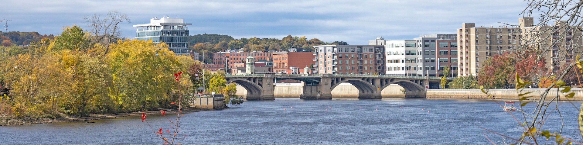 A view of the Haverhill skyline of the bridge and tall modern buildings. This small city in New England is brick and glass buildings. Haverhill Massachusetts MA during the fall and autumn with leaves