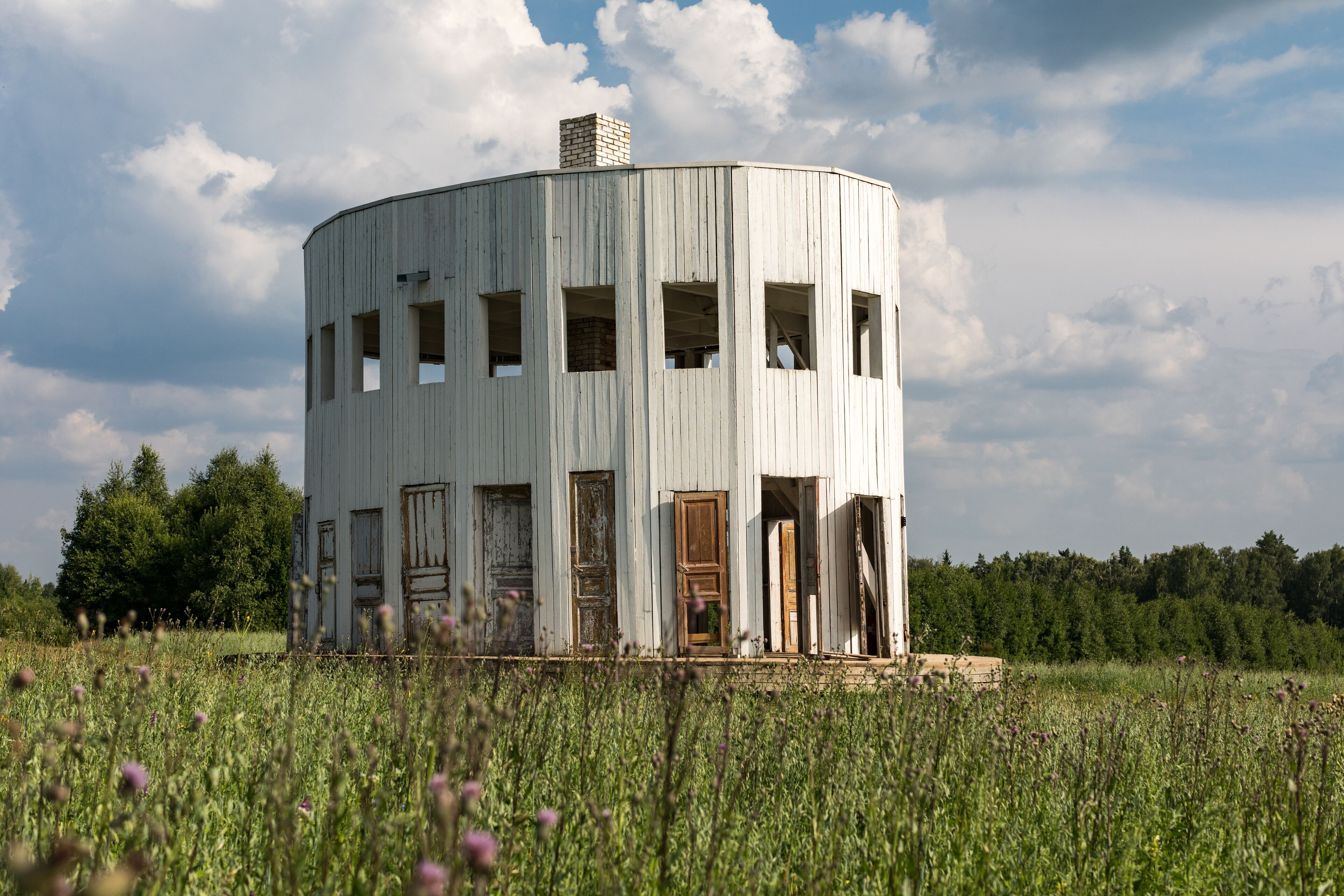 White wooden rotunda with many doors